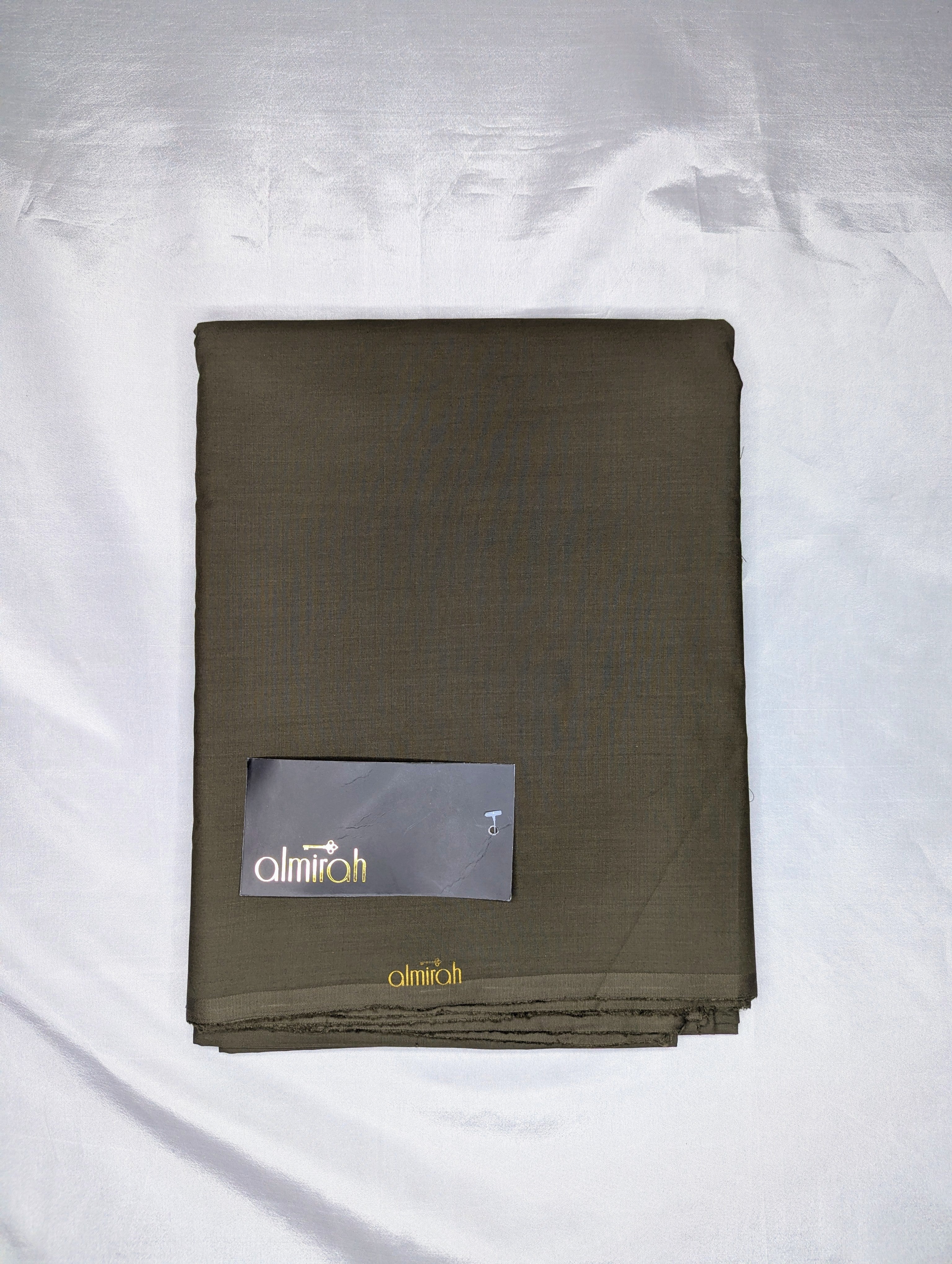 Folded brown fabric with a brand label on a white backgroundAlmira Fabric, Almira Wash and Wear, Unstitched Fabric, Plain Fabric, Wash and Wear Material, Summer Fabric, Formal Fabric, Casual Wear Fabric, Mens Fabric, Gents Wash and Wear, Plain Wash & Wear, Soft Fabric, Comfortable Fabric, Durable Cloth, Wrinkle-Free Fabric, Easy Care Fabric, Fine Quality Cloth, Unstitched Plain Suit, Solid Color Fabric, Polyester Viscose Blend, Smooth Finish Fabric, Shalwar Kameez Fabric, Kameez Shalwar Material, Kurta Fabr