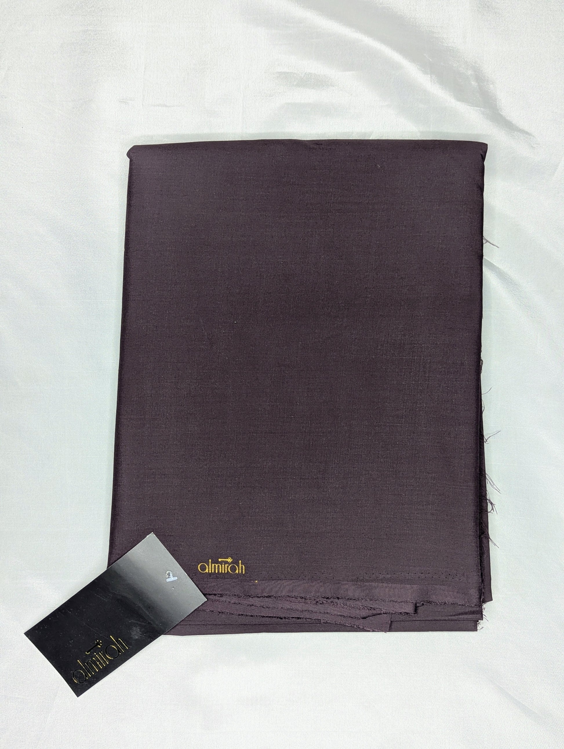 Folded dark purple fabric with a visible brand label on a white Almira Fabric, Almira Wash and Wear, Unstitched Fabric, Plain Fabric, Wash and Wear Material, Summer Fabric, Formal Fabric, Casual Wear Fabric, Mens Fabric, Gents Wash and Wear, Plain Wash & Wear, Soft Fabric, Comfortable Fabric, Durable Cloth, Wrinkle-Free Fabric, Easy Care Fabric, Fine Quality Cloth, Unstitched Plain Suit, Solid Color Fabric, Polyester Viscose Blend, Smooth Finish Fabric, Shalwar Kameez Fabric, Kameez Shalwar Materibackground