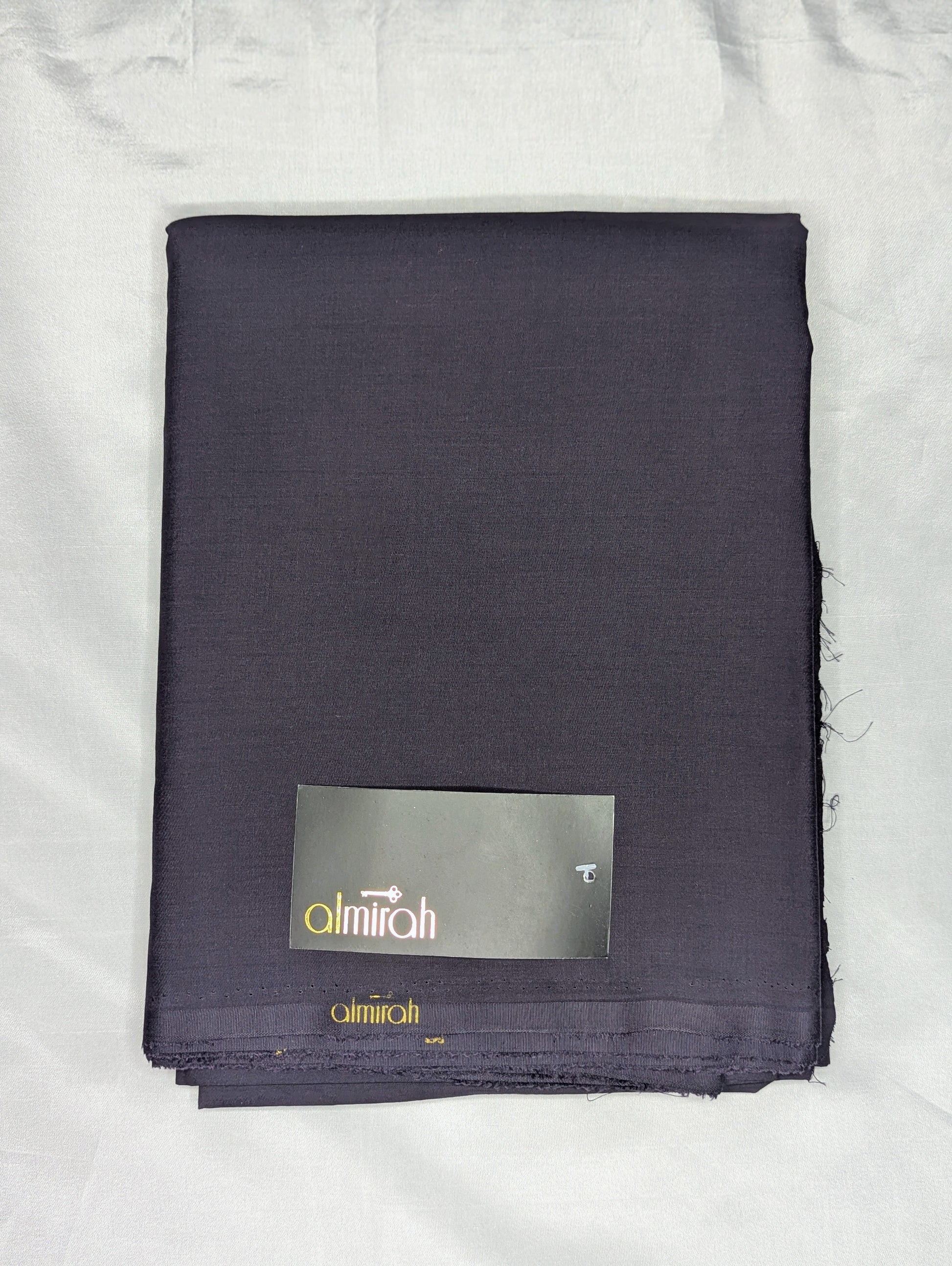 Folded dark fabric with a visible brand label on a white backgroundAlmira Fabric, Almira Wash and Wear, Unstitched Fabric, Plain Fabric, Wash and Wear Material, Summer Fabric, Formal Fabric, Casual Wear Fabric, Mens Fabric, Gents Wash and Wear, Plain Wash & Wear, Soft Fabric, Comfortable Fabric, Durable Cloth, Wrinkle-Free Fabric, Easy Care Fabric, Fine Quality Cloth, Unstitched Plain Suit, Solid Color Fabric, Polyester Viscose Blend, Smooth Finish Fabric, Shalwar Kameez Fabric, Kameez Shalwar Material, Kur