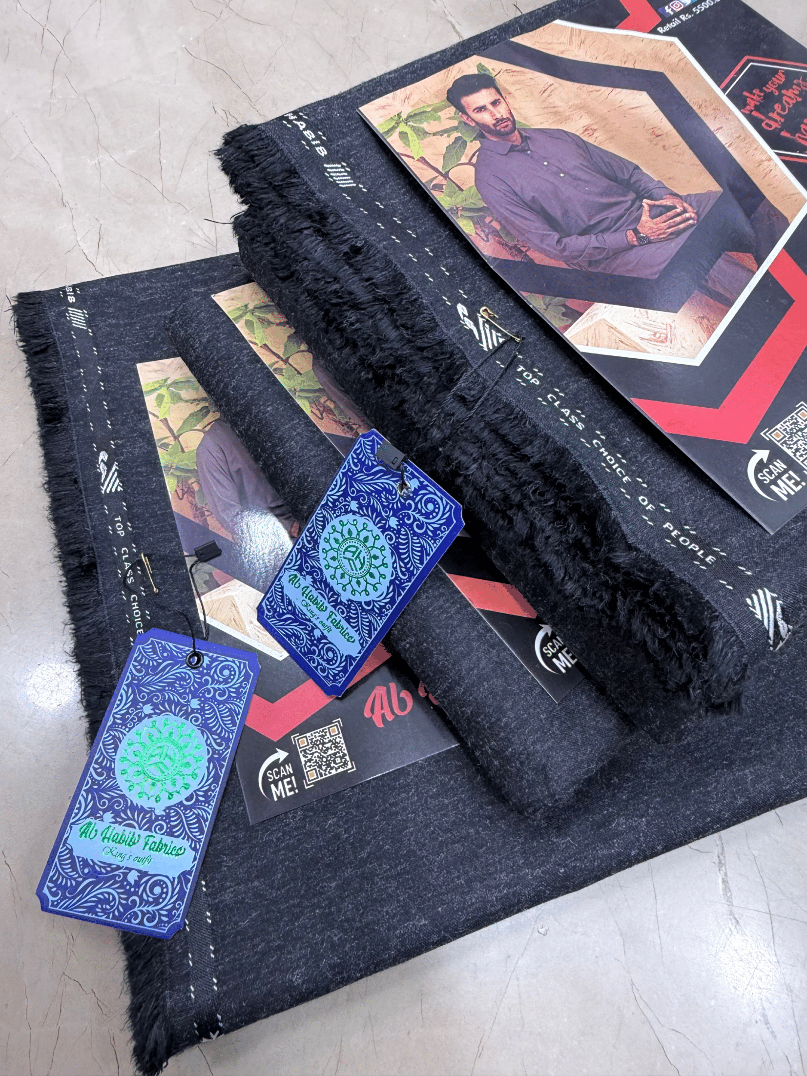 Black fabric with fringes and branded tags on a textured surface**AlHabibFabrics, AlHabibWinter, King'sOutfit, TopClassChoice, AlHabib, KashmirWool, WoolFabric, PremiumWool, SoftWool, WarmFabric, UnstitchedWool, SuitingWool, Men'sSuiting, UnstitchedFabric, ShalwarKameezFabric, KurtaShalwarFabric, Men'sDressMaterial, PremiumSuit, LuxuryMenswear, ElegantFabric, FormalWearMen, BestWinterFabric, NavyBlue, CharcoalGrey, DarkBrown, DeepBlue, MaroonFabric, GreySuit, PlainColors, PakistaniFabric, Menswear, WinterWe