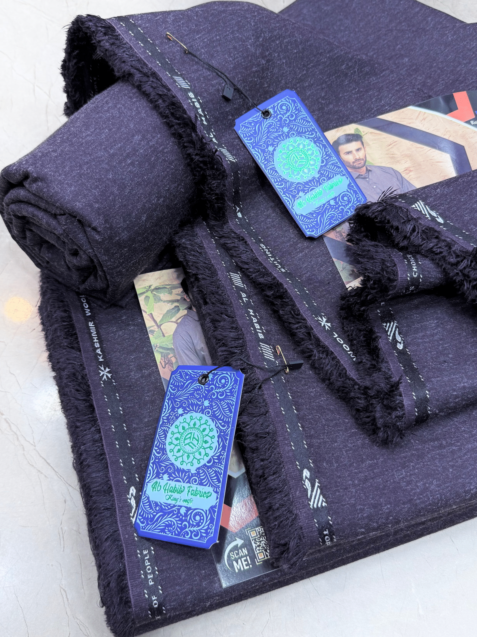 Folded dark blue fabric with tags on a light background**AlHabibFabrics, AlHabibWinter, King'sOutfit, TopClassChoice, AlHabib, KashmirWool, WoolFabric, PremiumWool, SoftWool, WarmFabric, UnstitchedWool, SuitingWool, Men'sSuiting, UnstitchedFabric, ShalwarKameezFabric, KurtaShalwarFabric, Men'sDressMaterial, PremiumSuit, LuxuryMenswear, ElegantFabric, FormalWearMen, BestWinterFabric, NavyBlue, CharcoalGrey, DarkBrown, DeepBlue, MaroonFabric, GreySuit, PlainColors, PakistaniFabric, Menswear, WinterWearPakista
