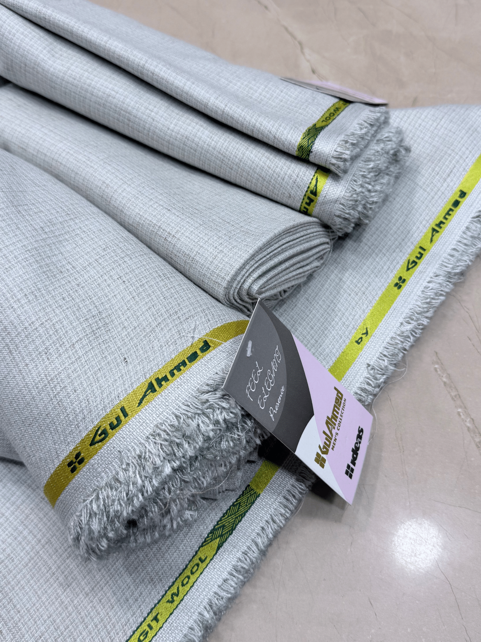 Roll of fabric with a brand tag on a light-colored floorGulAhmedMen,UnstitchedFabric,MensSuiting,GilgitWool,IdeasMens,PremiumFabricPakistan,WinterSuiting,GulAhmedSuits,SophisticatedOutfits,ShalwarKameezFabric, GulAhmedFabric,IdeasMen,UnstitchedSuits,MenWoolFabric,WinterCollection,MensDressMaterial,UnstitchedWoolSuit,GulAhmedOnline,MensEasternWear,PakistaniSuits, LuxuryMensFabric,FineWool,GilgitWoolSuiting,ElegantPresence,ClassicMenswear,UnstitchedWinter,FormalSuiting,GentlemanFabric,GulAhmedNewCollection,L