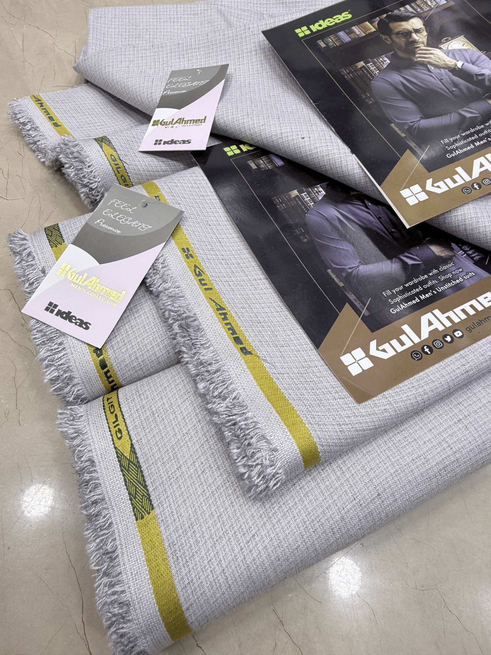 Gray textured fabric with yellow stripes and 'Gul Ahmed' branding on packaging.GulAhmedMen,UnstitchedFabric,MensSuiting,GilgitWool,IdeasMens,PremiumFabricPakistan,WinterSuiting,GulAhmedSuits,SophisticatedOutfits,ShalwarKameezFabric, GulAhmedFabric,IdeasMen,UnstitchedSuits,MenWoolFabric,WinterCollection,MensDressMaterial,UnstitchedWoolSuit,GulAhmedOnline,MensEasternWear,PakistaniSuits, LuxuryMensFabric,FineWool,GilgitWoolSuiting,ElegantPresence,ClassicMenswear,UnstitchedWinter,FormalSuiting,GentlemanFabric,G