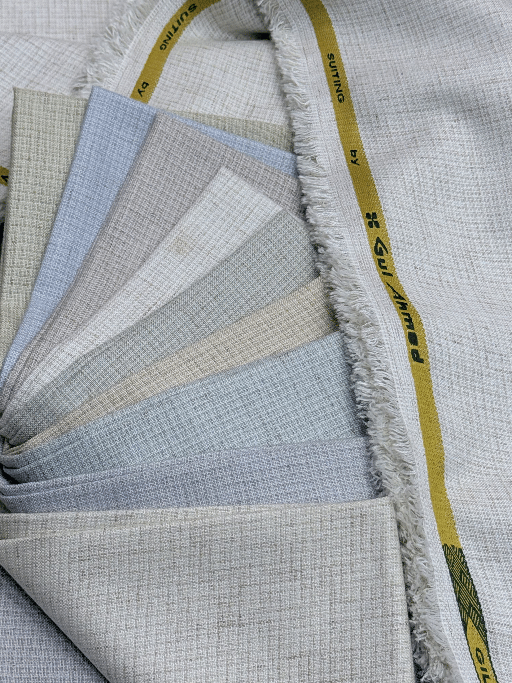 Fabric swatches arranged in a circular pattern with visible brand GulAhmedMen,UnstitchedFabric,MensSuiting,GilgitWool,IdeasMens,PremiumFabricPakistan,WinterSuiting,GulAhmedSuits,SophisticatedOutfits,ShalwarKameezFabric, GulAhmedFabric,IdeasMen,UnstitchedSuits,MenWoolFabric,WinterCollection,MensDressMaterial,UnstitchedWoolSuit,GulAhmedOnline,MensEasternWear,PakistaniSuits, LuxuryMensFabric,FineWool,GilgitWoolSuiting,ElegantPresence,ClassicMenswear,UnstitchedWinter,FormalSuiting,GentlemanFabric,GulAhmedNname.